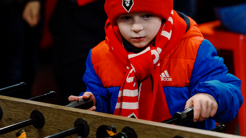 Yuong fan playing table football in Buck's Bar Feb25.png